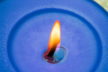 blue wax candle with burning flame