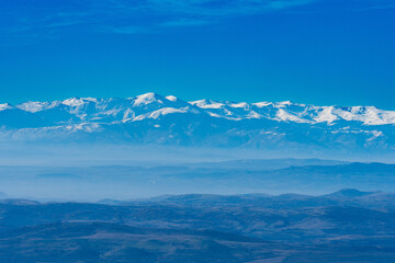 Mountain peak covered with snow. Horizon view. Winter landscape. Blue sky. Layers. Somewhere in Macedonia 2023