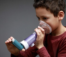 child with flu and inhaler respiratory puff on grey background with people stock image stock photo 
