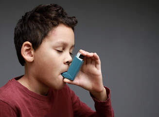 child with flu and inhaler respiratory puff on grey background with people stock image stock photo 