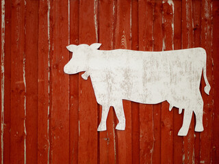Red rustic wooden barn facade..  with cow stencil for text, farming concept