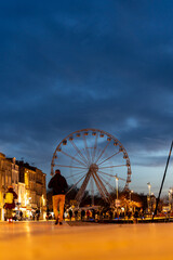 Cityscape of La rochelle with towers and great wheel, France. night shot