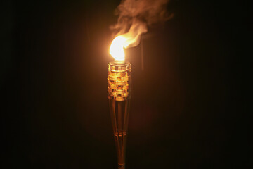 A kerosene torch burning in the dark