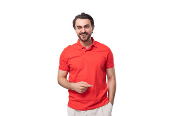 young smart brunette man with a beard is dressed in a red T-shirt on a white background with copy space