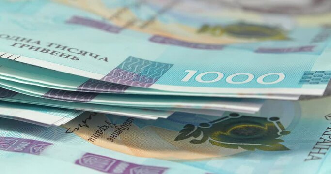 Money of Ukraine. New banknotes 1000 Hryvnia in uncirculated condition, UNC. Real Ukrainian paper money of blue yellow color, UAH. Ukrainian banknotes of max denomination. Cinema 4K 60fps video