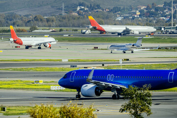 Departure air traffic with a blue plane at Madrid Barajas airport - obrazy, fototapety, plakaty