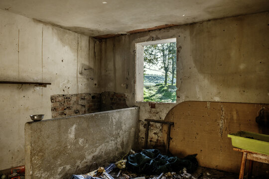 A room in an abandoned building full of waste, dirt and everything in a deplorable state