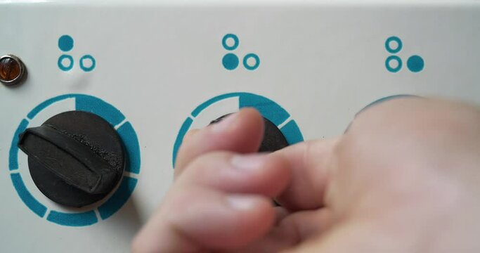 Switching off the electric stove. Man turns off the electric stove. Man hand turns the three switch of a three burner of kitchen stove. Energy saving. Cinema 4K 60fps video