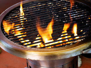 Open Flames In Barbecue Grill With Aluminum Foil Lining