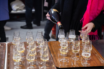 Many small tasting glasses of sparkling wine champagne on winter festival in December, Avenue de Champagne, Epernay, Champagne region, France
