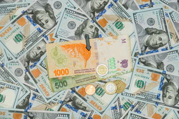 Argentina Banknotes And Coins With Black Arrow Heading Downward On US Dollars Background. Meaning...