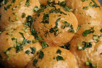 Traditional pampushka buns with garlic and herbs, closeup
