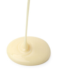 Pouring tasty condensed milk isolated on white