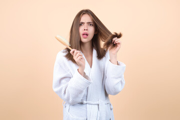 Messy hair. Brunette woman with messed hairs. Girl with bad frizzy hair. Sad woman having bad hairs. Tangling hairs is messy and tangled. Hair loss woman with a comb and problem hair. Hairloss woman. - obrazy, fototapety, plakaty