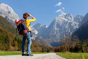 Fototapeta na wymiar Woman Backpacker Looking Mountains Far Away on Her Road
