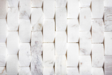 Arched white marble tiles for wall or floor. Natural white modern tile used for bathrooms, kitchen backsplash or featured walls. Upward curved or cambered 2x4 tile, flat lay. Selective focus. - obrazy, fototapety, plakaty