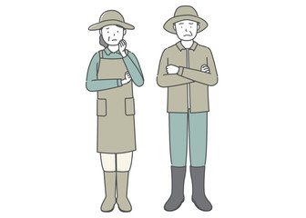困った表情の農家の中高年夫婦