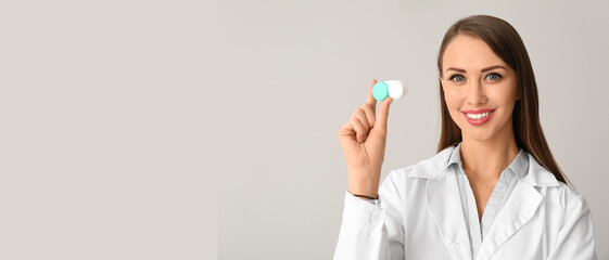 Ophthalmologist with contact lenses on grey background. Banner for design