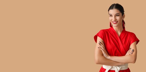 Beautiful young woman on beige background with space for text. Chinese New Year celebration