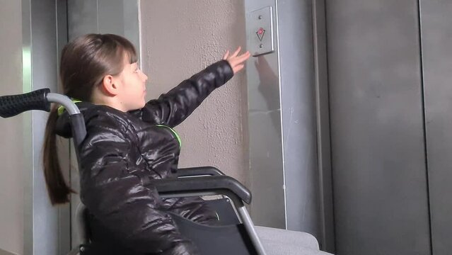 Disabled girl in wheelchair decided to use elevator independently. Lifestyle of child with special needs