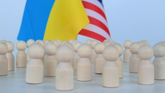 Flags of the United States of America and Ukraine together and people society. Conceptual basis for the partnership between Ukraine and the United States during war