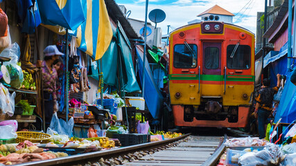 Maeklong Railway Market Thailand, Train on Tracks Moving Slow Umbrella Fresh Market on the Railroad Track, Mae Klong Train Station, Bangkok a famous railway market in Thailand - obrazy, fototapety, plakaty