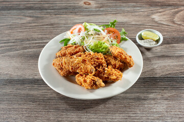 A view of a plate of deep fried chicken wings.