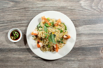 A top down view of an entree of shrimp fried rice.