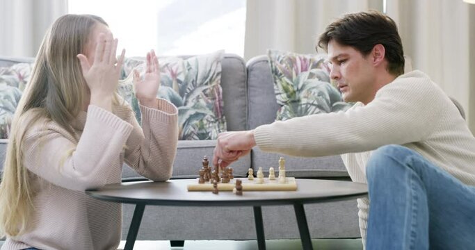 Couple, chess game or playing in home with strategy, plan or mental health for brain power. Happy woman, loser or smart man in a fun board match for problem solving or challenge to relax in apartment