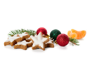 Composition with delicious stars shaped Christmas cookies, balls and fir tree branches on white background
