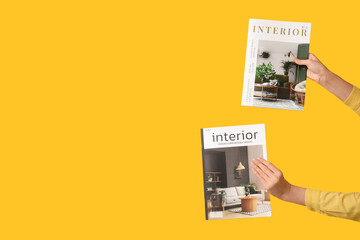 Young woman with interior magazines on yellow background