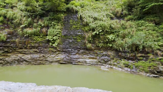 Cinematic gimbal shot of forest trail leading to steam vents at Oyasukyo Gorge in Akita prefecture in Japan