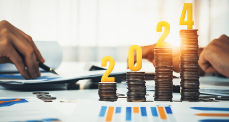Growth coin stack symbolizing business investment and economic growth. Business people doing financial planning to achieve financial goal and contribute maximum profit on new year 2024 . Shrewd