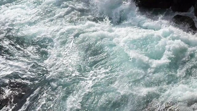Green energy. Renewable energy sources. Perpetual motion machine. Power of nature. Water element. Limited natural resources. Sea waves break into white foam on the coastal rocks