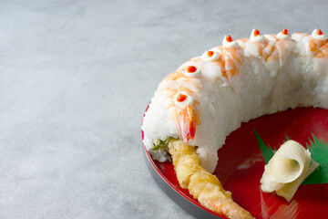 A view of a tiger sushi roll on the right side of the frame.