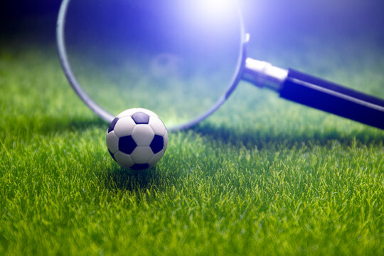 football score result prediction , online soccer betting , ball with magnufying glass on green field