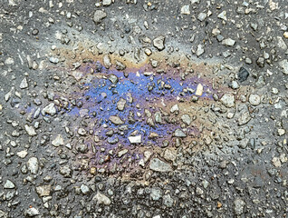 A trace of gasoline on the asphalt as a background. Texture
