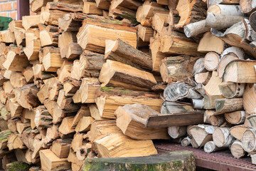 Stacked firewood. Preparation of firewood for the winter. Stocks of wooden firewood. Stacked firewood. Village lifestyle.