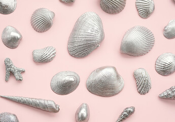 Silver sea shells arrange on pink.