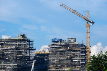 A tower crane is operating a multi-storey residential building.