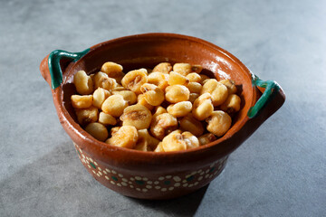 A view of a bowl of corn kernel snacks.