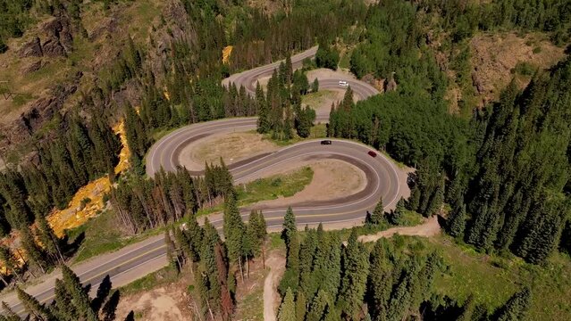 Million Dollar Highway aerial video of cars driving up snake shaped windy road