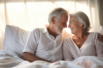 Obraz premium Love lives forever. Senior couple at home. Handsome old man and attractive old woman are enjoying spending time together while lying in bed.