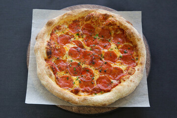 hot pepperoni pizza with green basil close-up