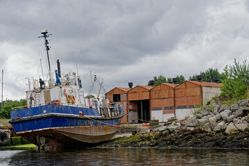Fototapeta na wymiar Old steel blue boat moored in the west coast highlands, Scotland