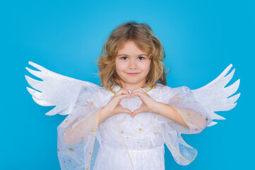Valentine angel. Little cupid child. Kid angel with angels wings, isolated on blue studio...