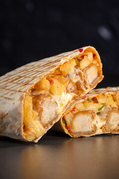 French tacos with chicken popcorn. Served with french fries on a black background