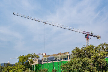 tower cranes on construction site, providing housing for low-income citizens of third world...