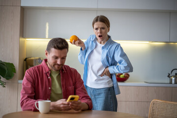 Surprised shocked wife unnoticeable looking into husbands mobile phone while man secretely texting...