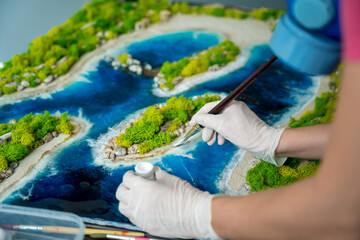 The process of making the art decor of epoxy resin, natural stones and moss - obrazy, fototapety, plakaty